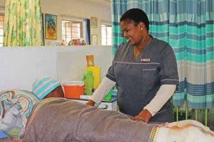 Hact Caregiver Philisiwe Magoso Tending To A Patient In The Respite Unit 002 300x200