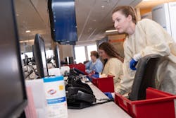 Microbiology Technologists logging samples in LIS Microbiology Technologists logging samples in LIS