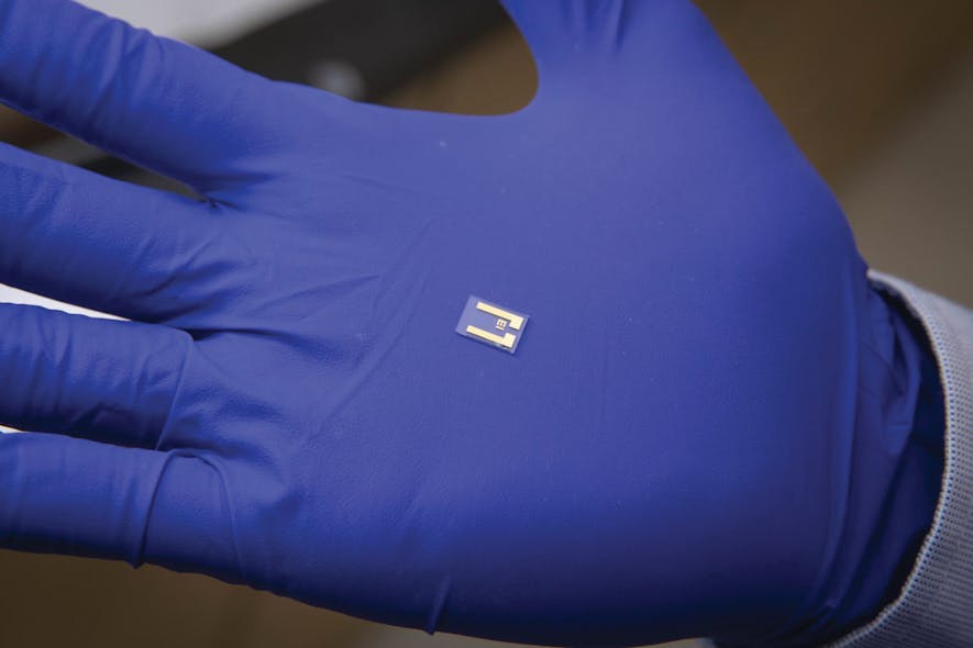 WPI post-doctoral fellow Sadegh Mehdi Aghaei holds a single chip in his gloved hand.