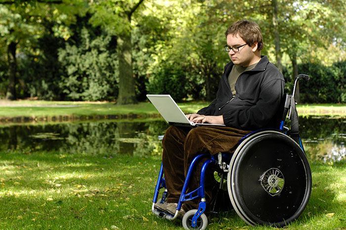 Man In Wheelchair Reading Laptop 5f3538d3cbfab
