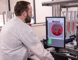 Cory Gunderson reading plates in microbiology. Cory Gunderson reading plates in microbiology.