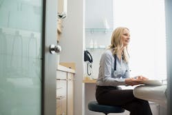 femaledoctorwithmedicalrecordsittingexaminationroo femaledoctorwithmedicalrecordsittingexaminationroo