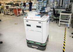 Figure 2: A robot works alongside humans in a semi-dark lab in a test conducted by Siemens Healthineers, United Robotics Group, and HUS Diagnostic Center.