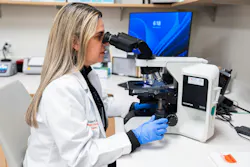 Technologist at microscope. Technologist at microscope.